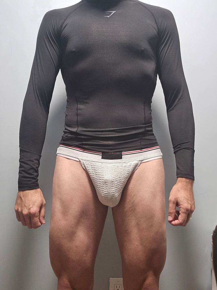 Im in a compression shirt and white sports jock. My cage line is visible.