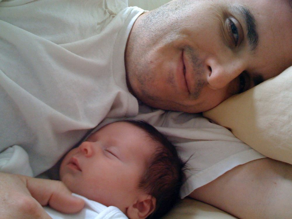 Charlie at a few weeks old, sleeping with me in bed.