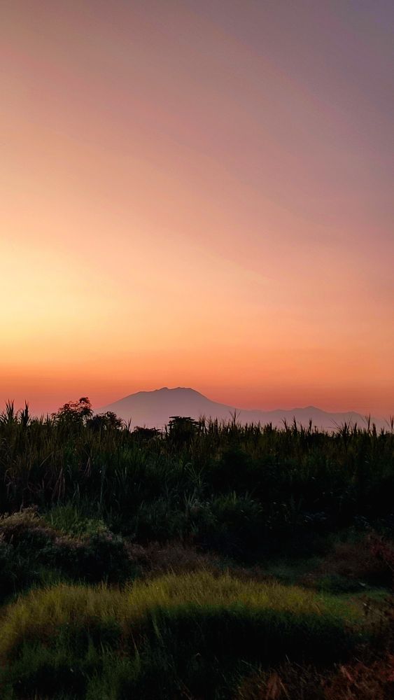 early morning sky and a mountain in the background