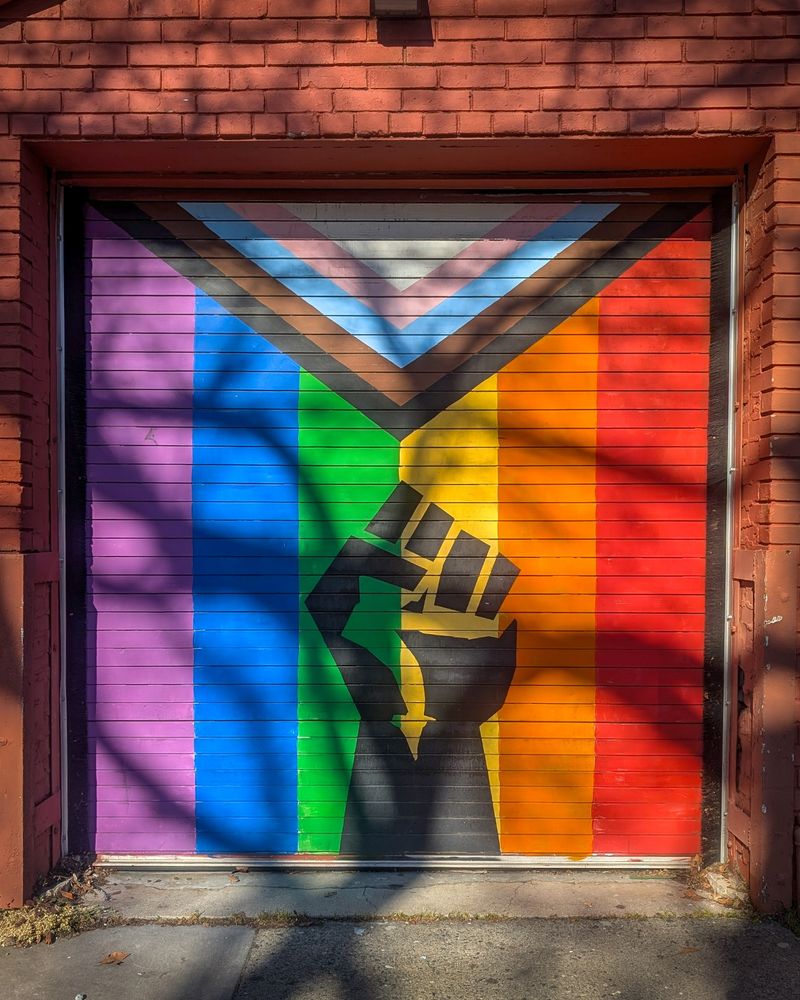 Progressive Trans flag mural with a social justice fist in the middle. 