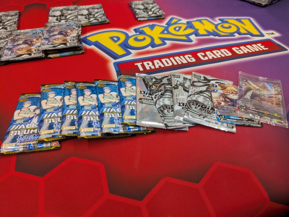 A spread of digimon packs and promos
