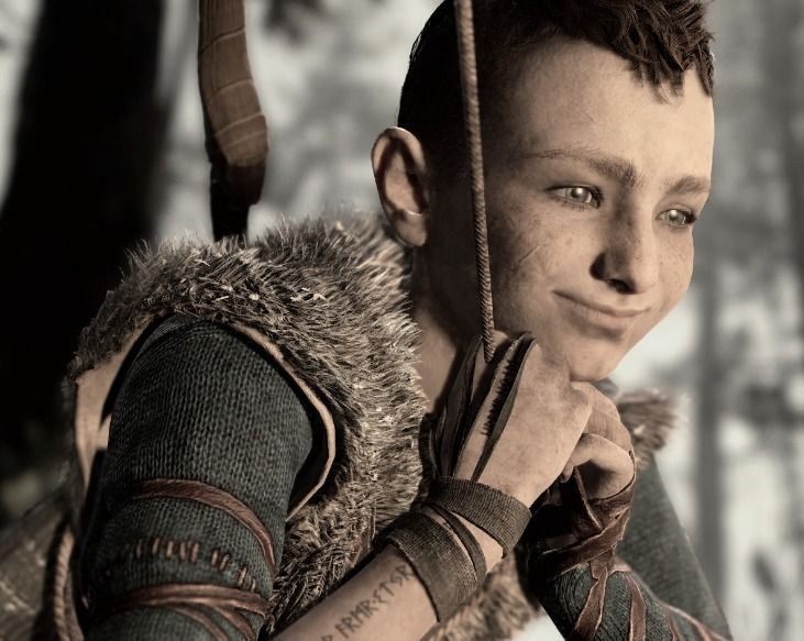 Atreus from God of War 2018 sitting with his hands below his head smiling and looking pleased.
