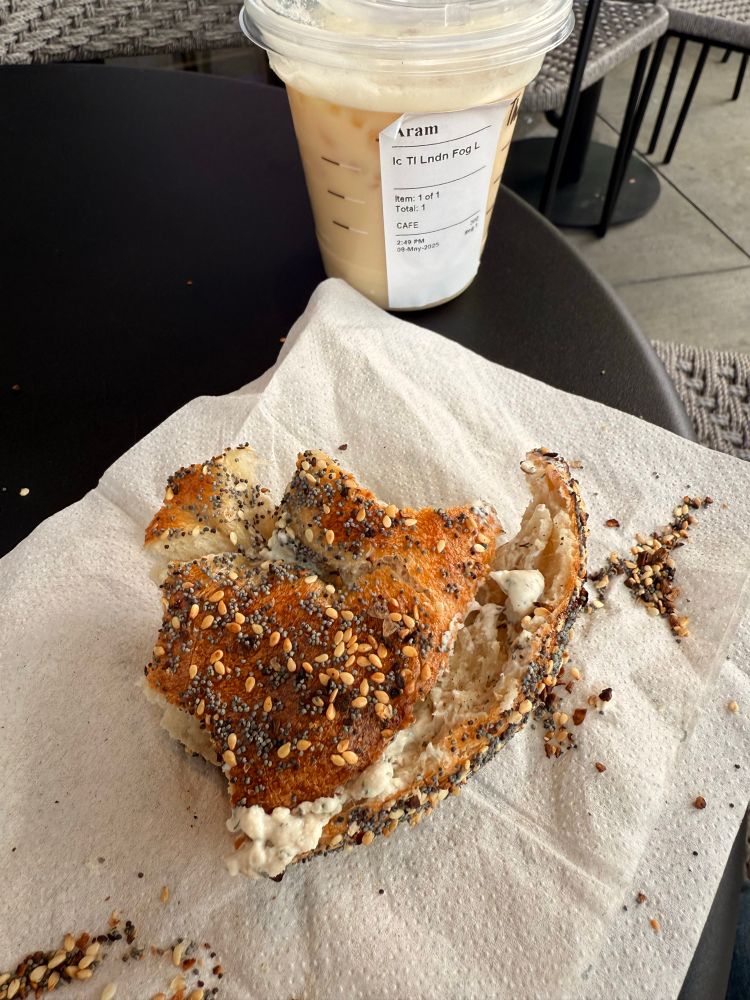 Photo of an Hey Bagel Everything Bagel with lox Schmear next to a 12oz london fog iced from Starbucks