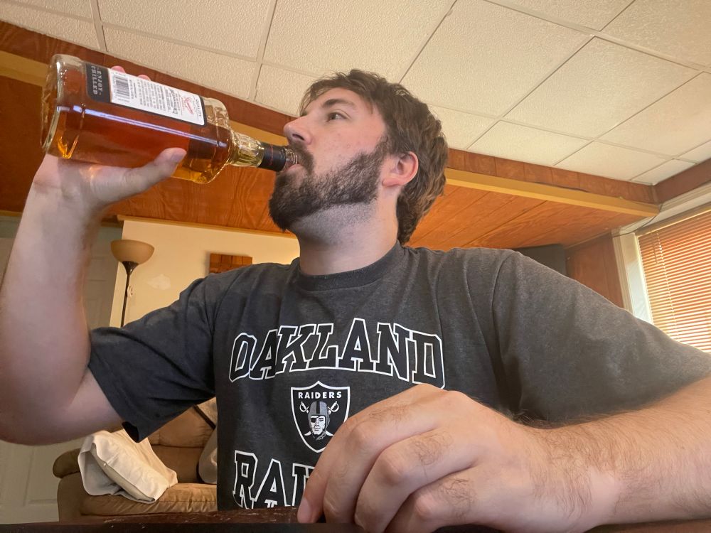 Local Raiders fan consumes alcohol in an attempt to numb the pain of having to watch his team embarrass themselves in a primetime game.