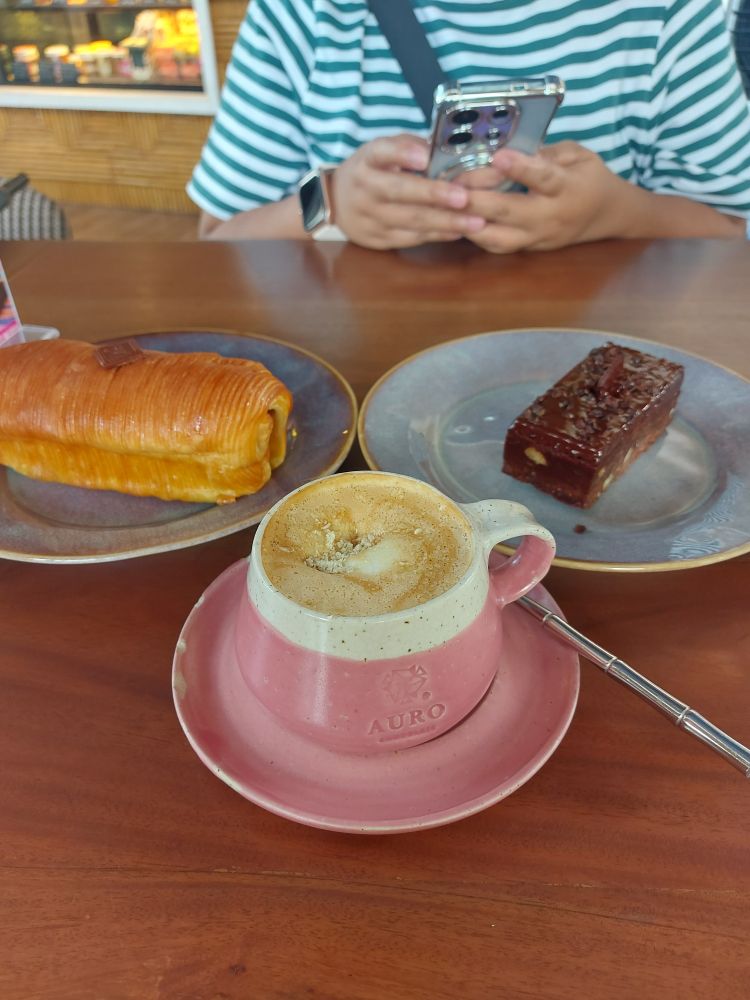 cup of spanish latte, a hazelnut fudge bar, and a pan au chocolait