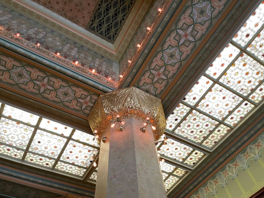 Color photo of a corner of the recreated Chicago Stock Exchange trading room floor now located inside the Art Institute of Chicago. In this one photo there are layers and layers of exquisite Sullivan details, found everywhere from wall stencils to art glass panels.