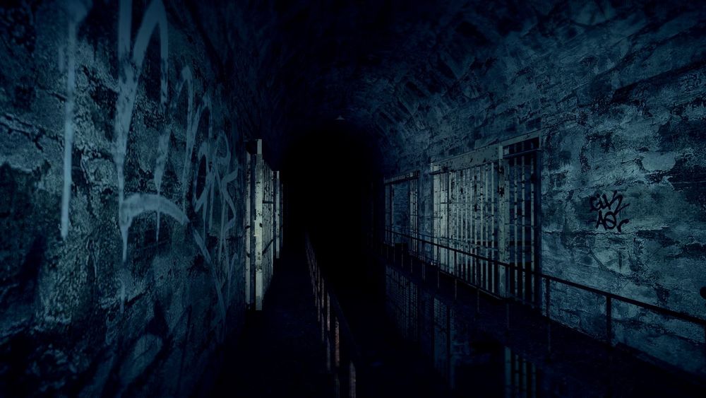 a screenshot of the map, showing an abandoned prison block plunged in darkness.