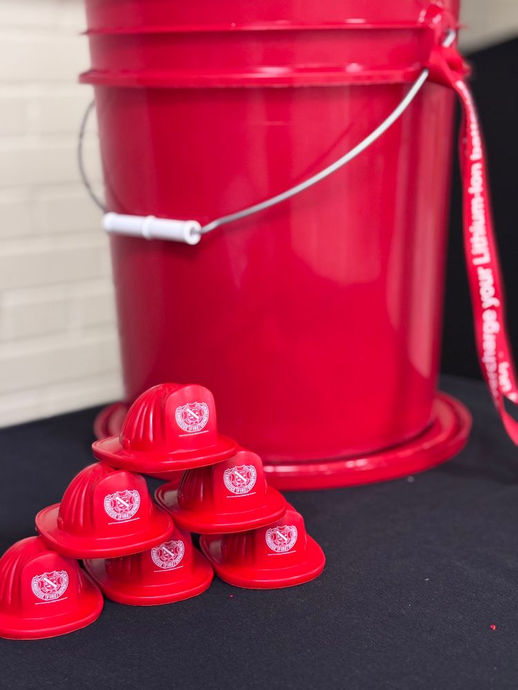 Squeeze fire helmets with a lithium-ion battery safety message ‘Don’t overcharge’.  