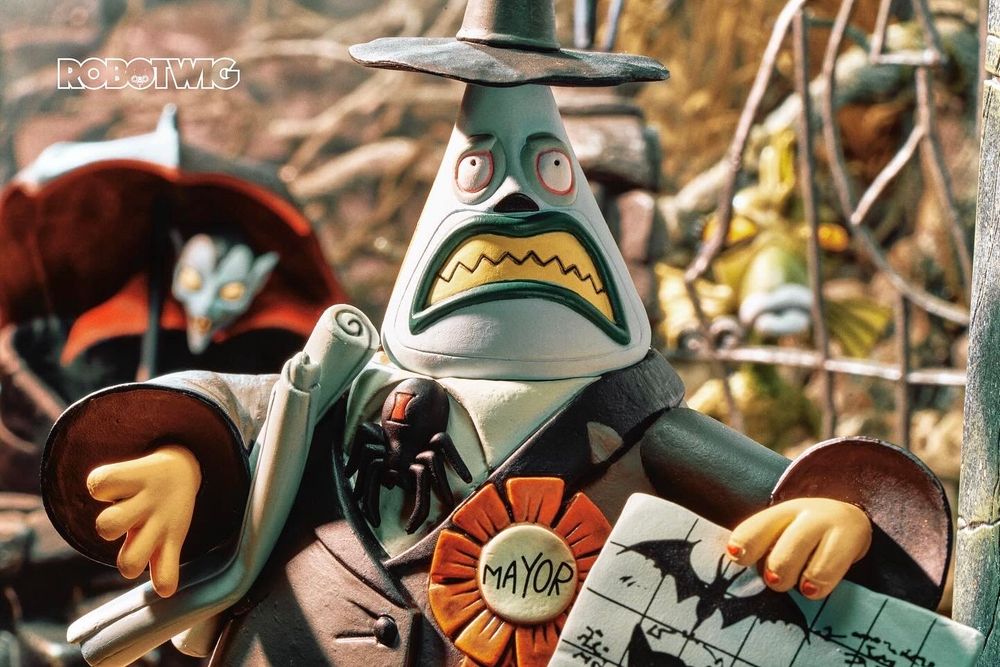 Mayor of Halloween town knocks on Jacks door but there's no reply. He has plans under his arms and one in his other hand. Residents of Halloween town are watching behind him