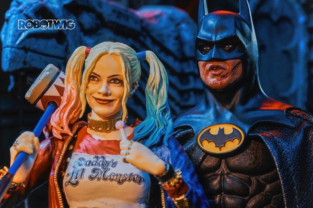 Harley Quinn (Margot Robbie) and Batman (Michael Keaton) look toward a giant explosion off camera. Harley Quinn smiles. Batman looks concerned.