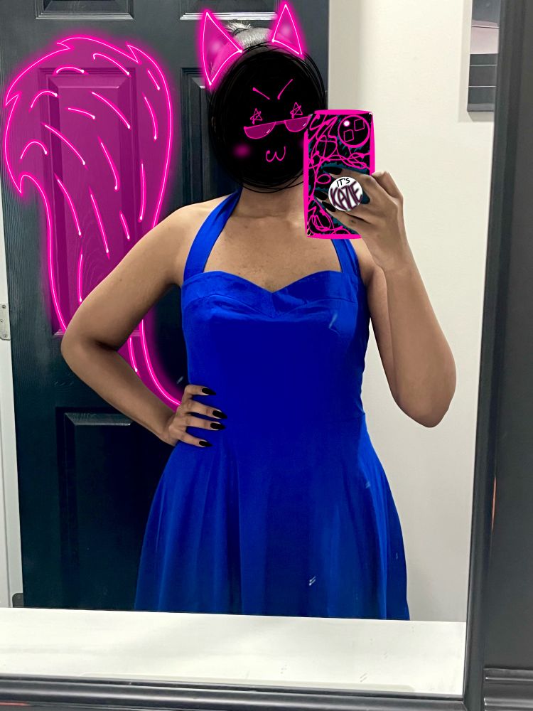 Me taking wearing a royal blue dress, taking a selfie in the mirror, face covered. 