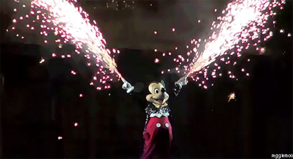 a picture of mickey mouse with fireworks coming out of his hands and the caption ieggkmoo