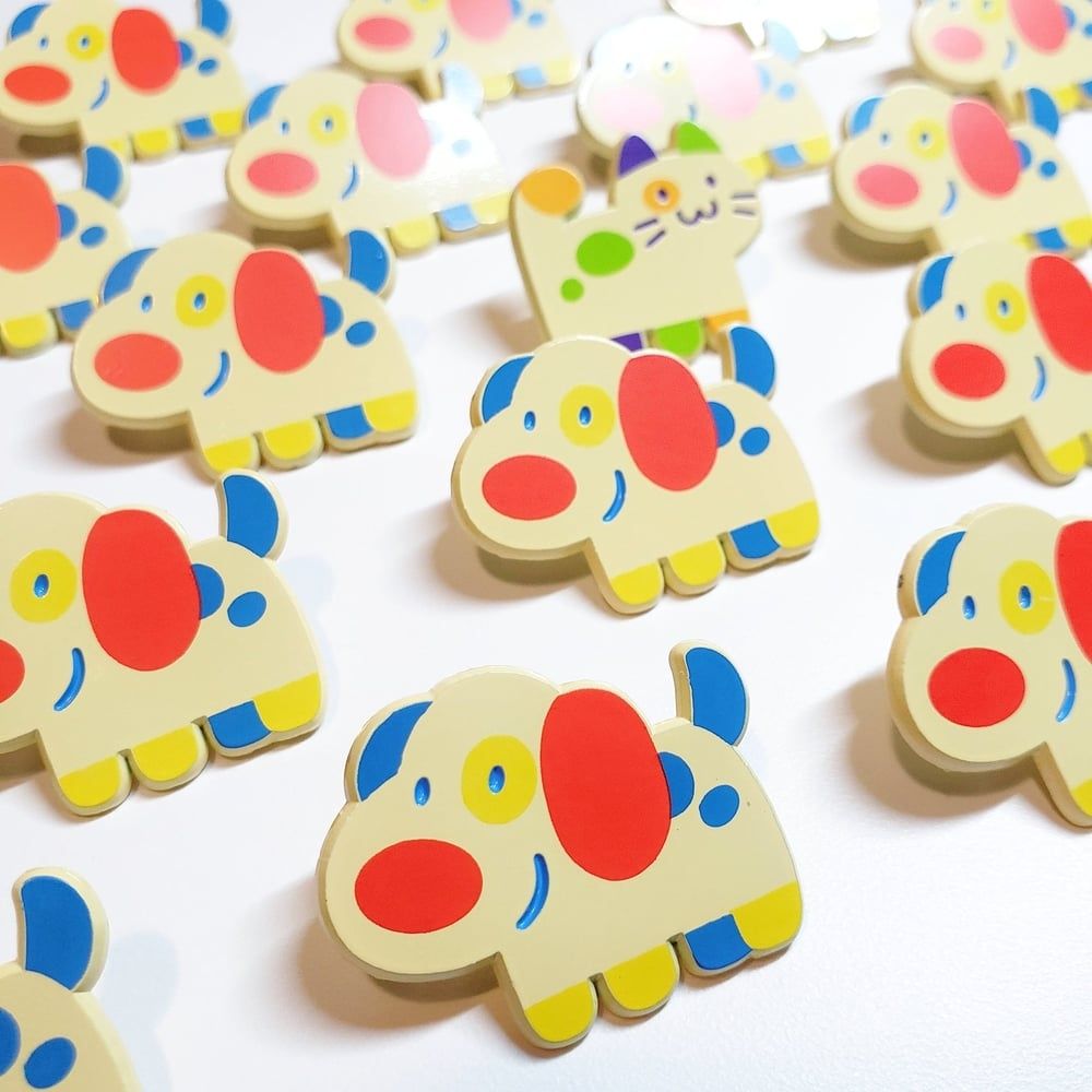 Enamel pins of a colorful dog