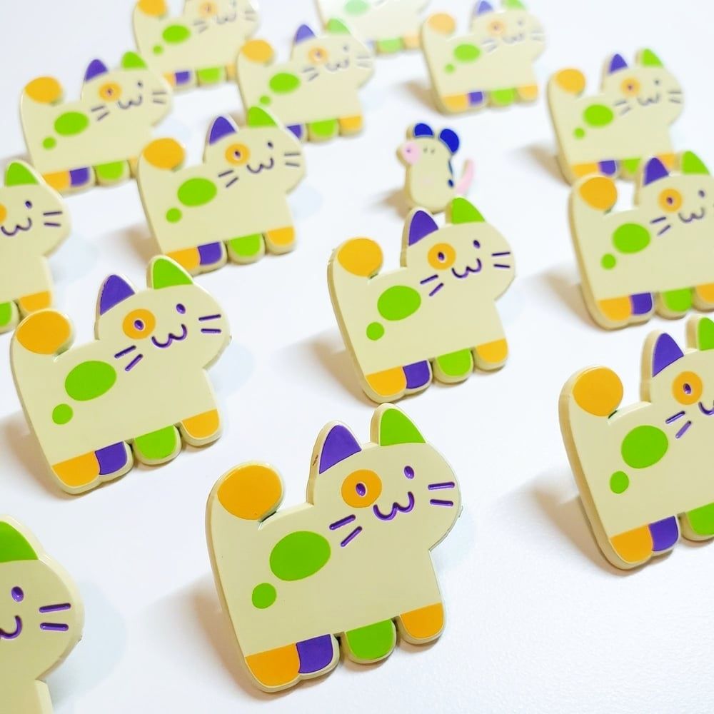 Enamel pins of a colorful cat