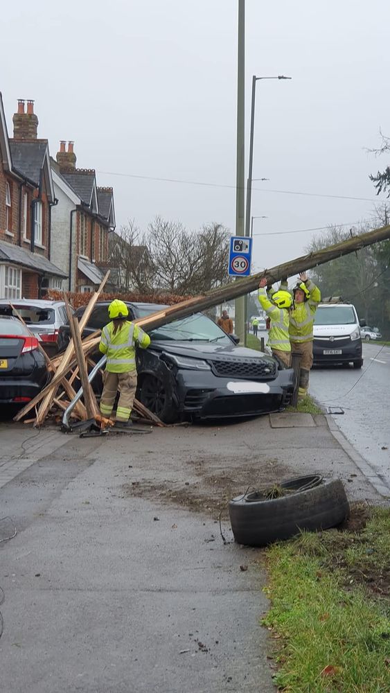 Photo of car mounted the pavement, crashed into a telegraph pole, knocking it clean over.