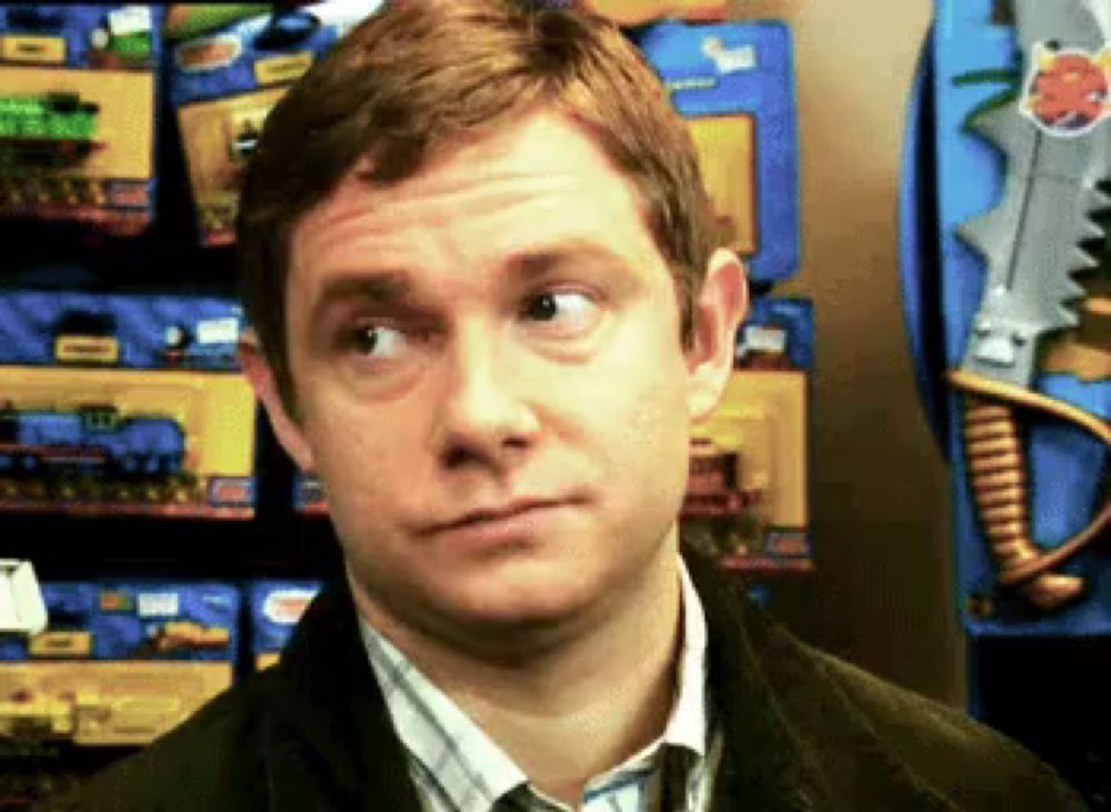 a man is making a funny face in front of a display of toy guns