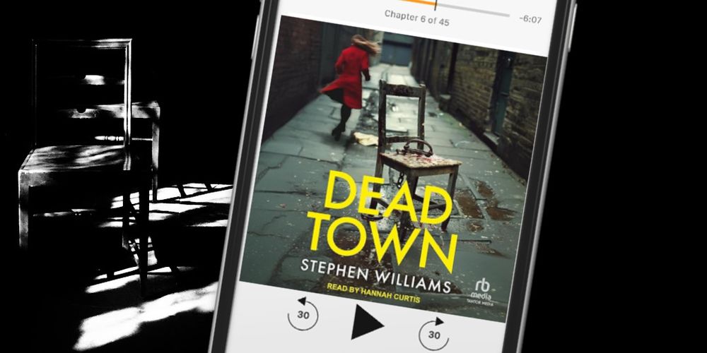 A chair cast in shadow and the audiobook cover of Dead Town on a smartphone. Cover shows chair in an alley with a woman in a red coat running. 