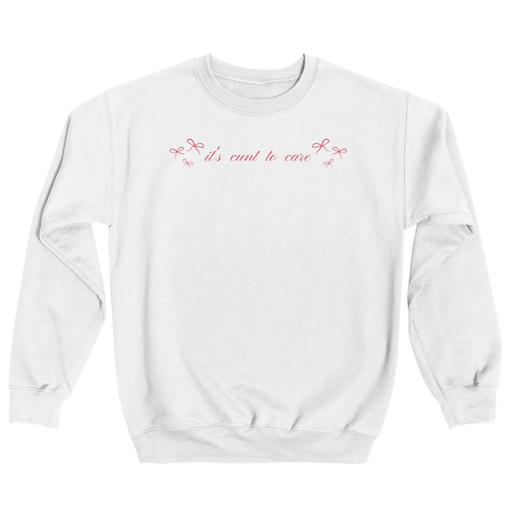 A white sweatshirt with dainty red bows and text that reads: "it's cunt to care."
