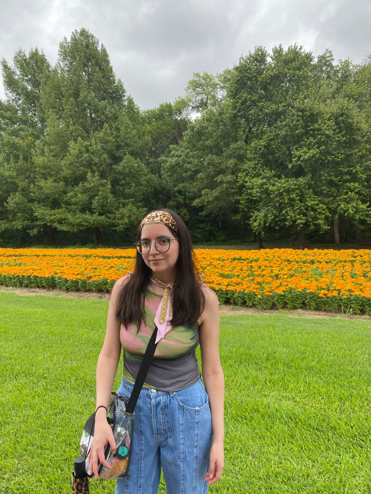 Another picture in front of the orange flowers, but from a distance.