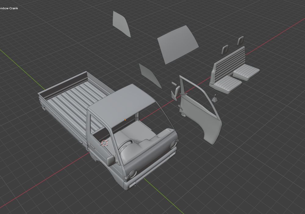 The image shows a gray, three-dimensional model of a kei truck, currently disassembled into its individual components – the cab, bed, and possibly other smaller parts – displayed on a dark, grid-based background.