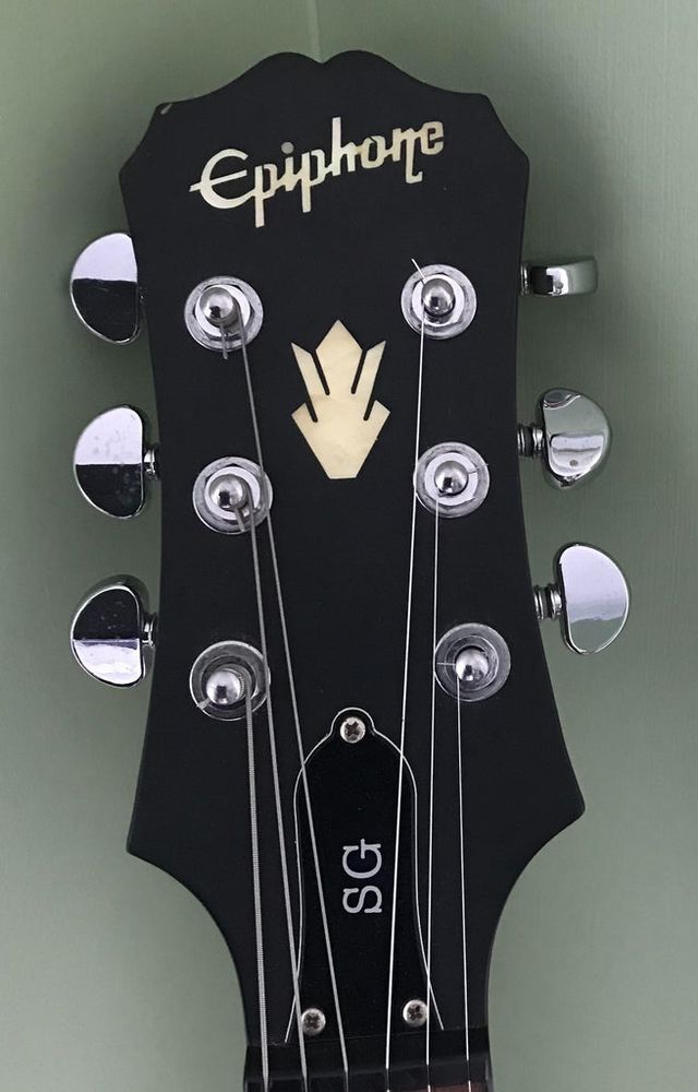 A picture of an Epiphone “clipped Gibson” headstock.  It makes me feel sad.