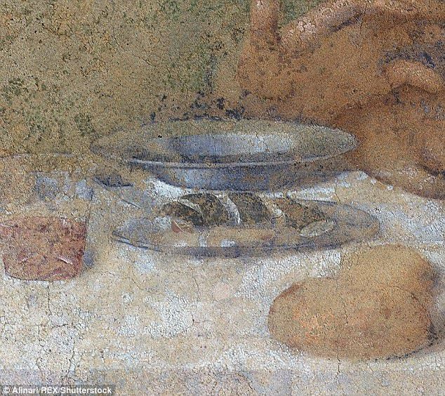 Closeup of the plate of eel and oranges from Da Vinci's Last Supper. The eel is sitting on a plate, cut up into 4 pieces. Little eel nuggets, if you will. There is a glass next to the plate with what we should probably assume is wine, but which could also be Mountain Dew Code Red. Wine makes more sense canonically. Mountain Dew makes more sense comedically. You decide.

There are several rolls on the table that look a bit like potatoes but can't possibly be, and a small bowl behind the eels. You can see a hand behind the bowl; it belongs to James the Greater. He seems like he's telling the eels to slow down, and use their walking feet. Which, is just silly, tbh.

One wonders if you could read his future from the lines on that hand: early martyrdom, a post-death sail to Spain, a pilgrimage by Shirley MacLaine...it's probably all right there.

I suspect that James the Greater probably wanted his friends to call him Big Jake, but it never happened. Life is full of such little tragedies. 