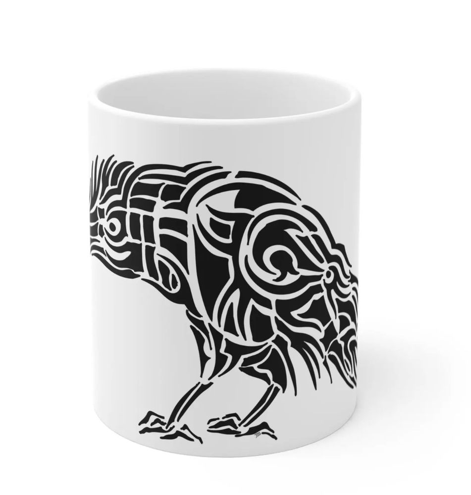 Black and white drawing of a raven on a coffee mug, looking away from you as if you've done something terribly wrong. This is made worse by the curve of the mug. The drawing is made of abstract shapes and lines.