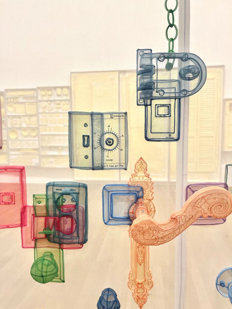 Artist Do Ho Suh's piece "Perfect Home". Exact replicas of plugs, doorknobs and latches rendered with translucent fabric affixed to the wall of a translucent fabric room. Each item is a different color: an ornate yellow doorknob, a chunky navy door latch and thermostat, red, blue, and green plugs overlaying a green round doorknob. The items are from different homes artist Do Ho Suh has lived in at their measured exact heights. 