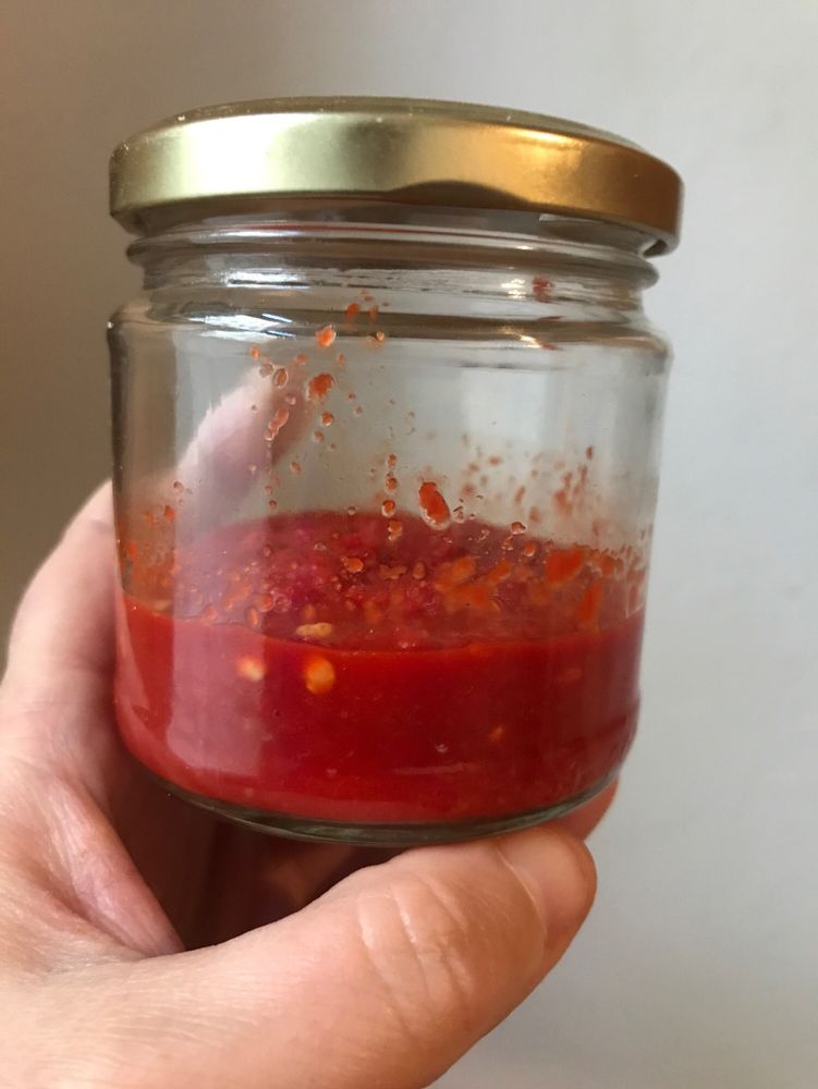 Ein Schraubglas mit einer roten Paste.