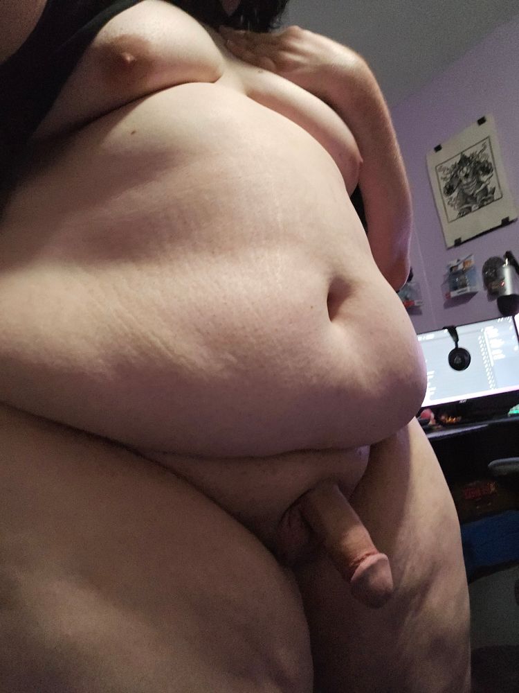 bimbo with her puppy girl cock out with her hand resting above her tits