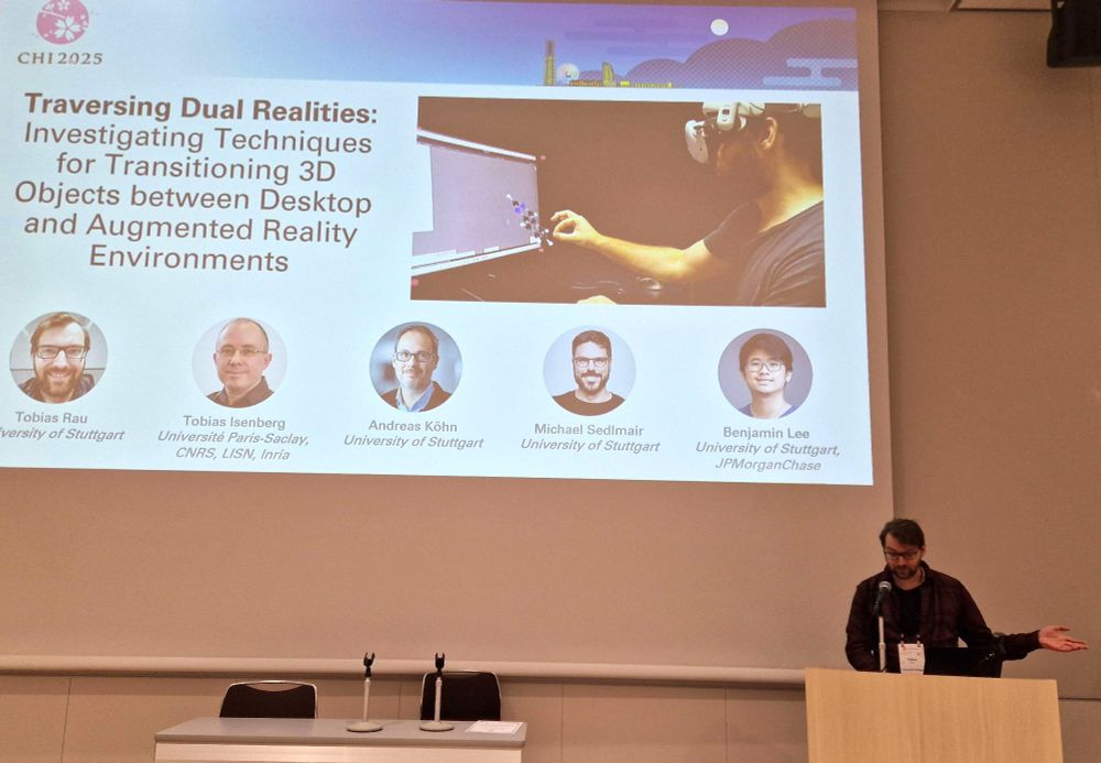 Picture showing Tobias during his presentation at the CHI2025. The title slide is shown in the background: "Traversing Dual Realities: Investigating Techniques for Transitioning 3D Objects between Desktop and Augmented Reality Environments". There is also a picture on the title slide showing a user who "pulls" a molecule "out of the screen" into a 3D hologram representation. (That's the connection to chemistry, if you wonder.) 