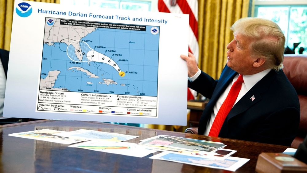 DJT holding map of SE US showing the path of hurricane Dorian with Trump's stupid sharpie mark altering the data. Facts are hard for this man.