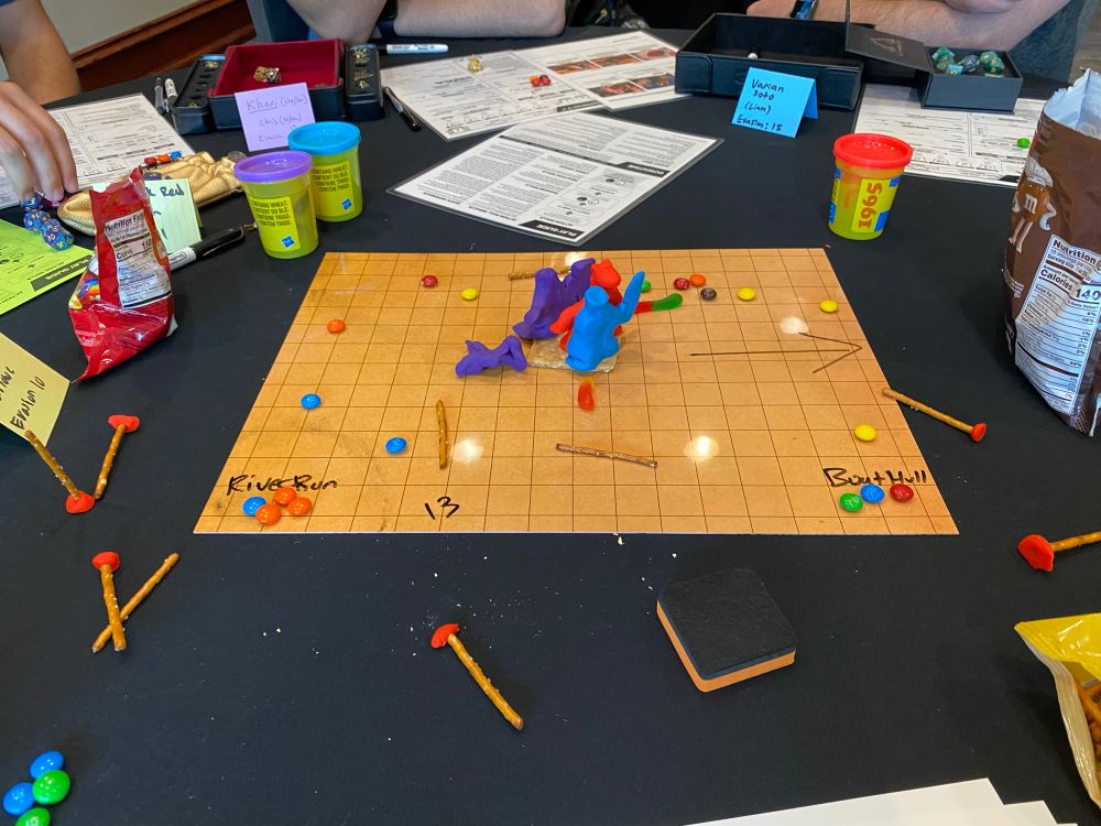 Battle map for a game of daggerheart using a variety of food for minis and terrain