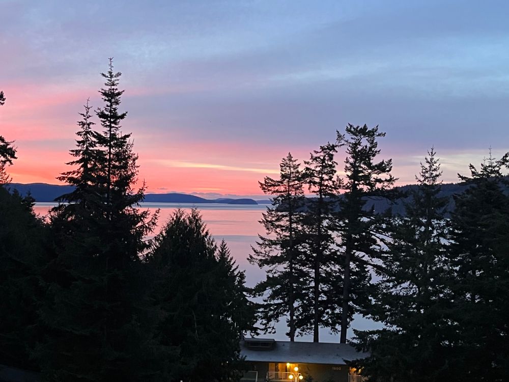 Sunrise with pink and orange skies over Cascade Bay on Orcas Island in Washington state.