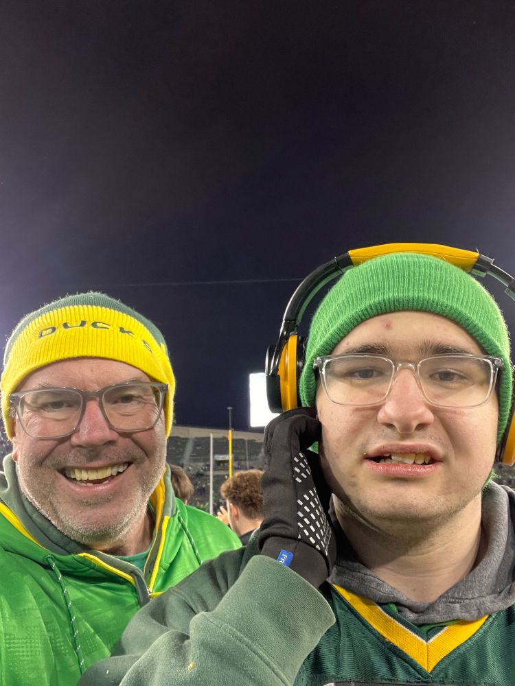 David and Stone on the field of Autzen Stadium after the Ducks beat the Huskies.