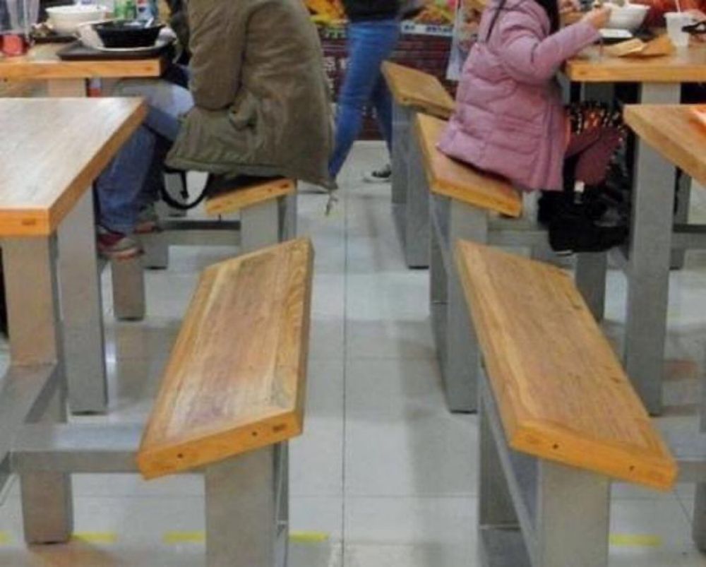 Lunch table seats leaned forward to cause discomfort in the legs to make you want to leave quicker 