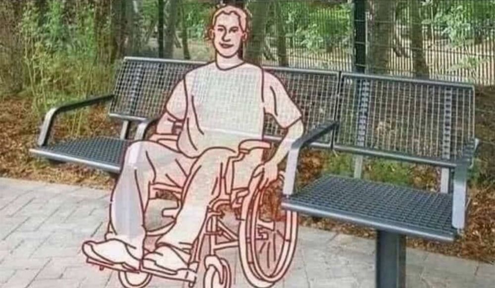 An illustration of a man using a wheelchair, positioned in a gap between two ends of a single bench