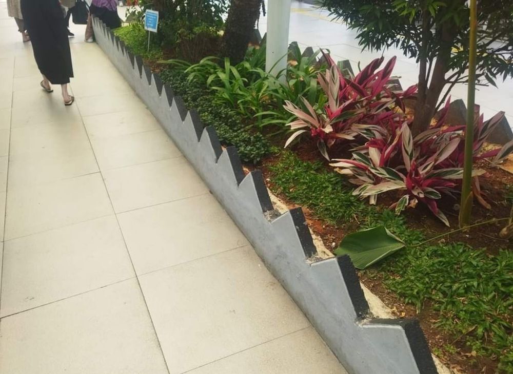 Low triangular fence around a gardened area
