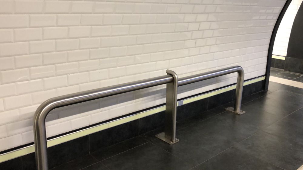 Two steel tubes of differing heights meant to be benches
