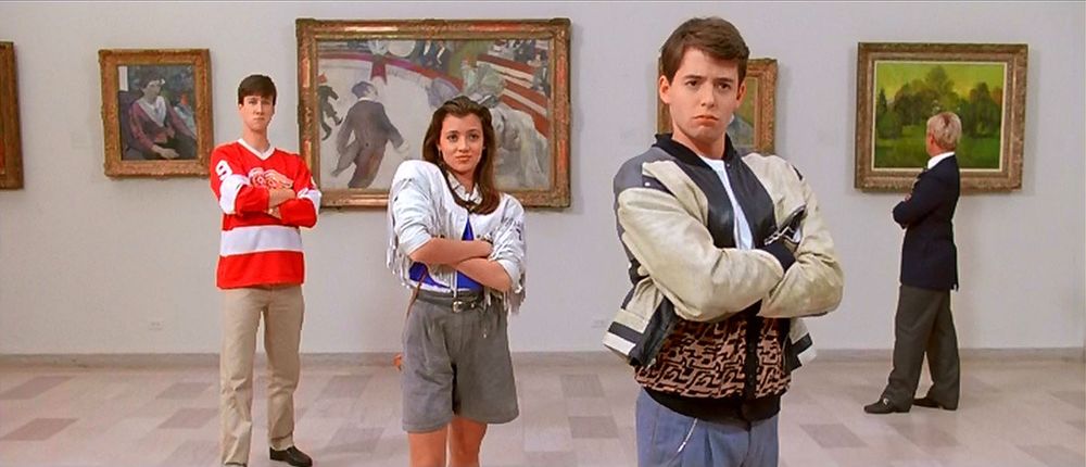 Movie still of three characters in Ferris Bueller’s Day off looking at art with arms crossed.