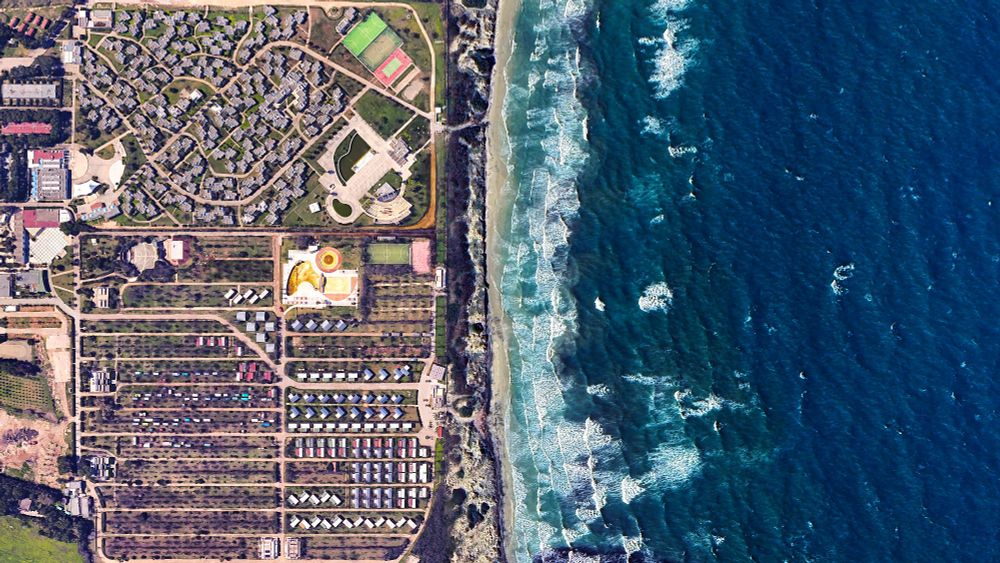 a satellite picture of a seaside resort complex and the sea. th picturee is split in two with the blue sea on the right and the resort + camping on the left