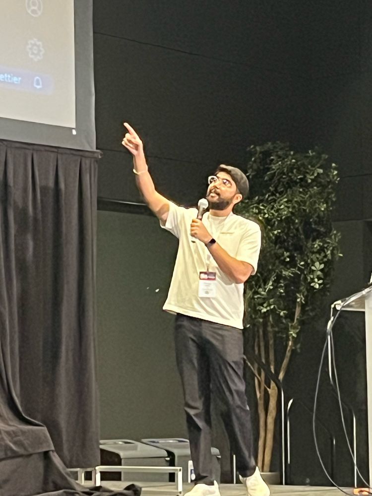 Rishab giving his talk at All Things Open