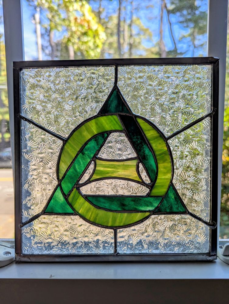 Green therian symbol against a clear florentine background