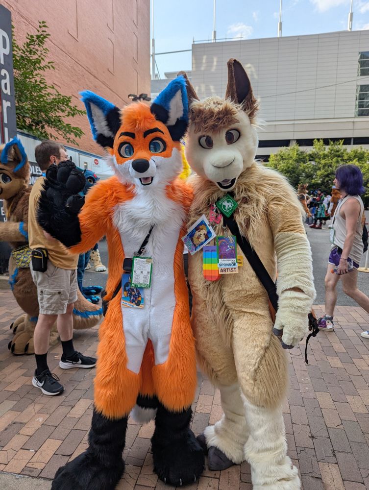 Orange and blue fox and tan alpaca fursuiters