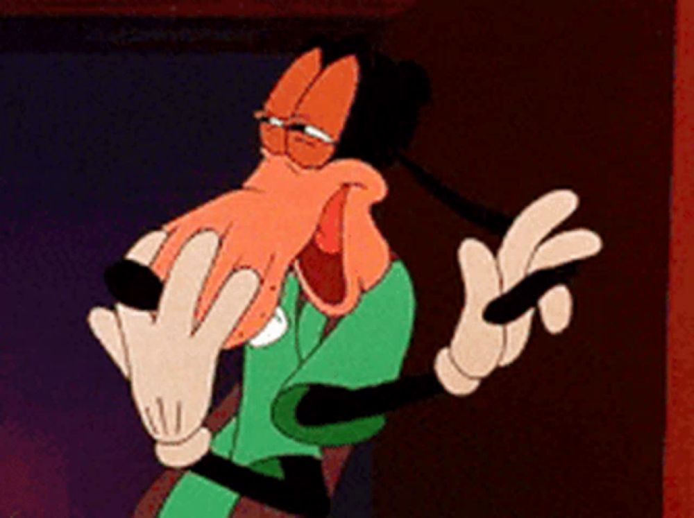 goofy is wearing a green shirt and white gloves and making a funny face .