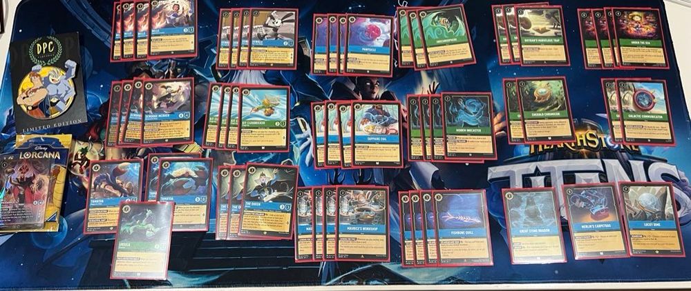 Lorcana Deck spread, plus my winnings (2 packs, the promo card, and a cool custom pin thing the shop gave out).