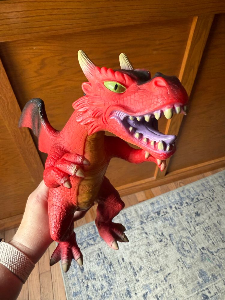 Red dragon toy that has horns. 