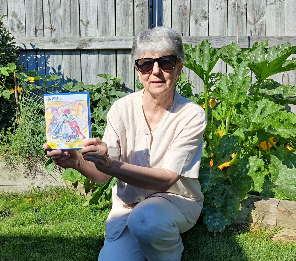 Me in sunny garden holding PS5 copy of Tales of Graces F Remastered.