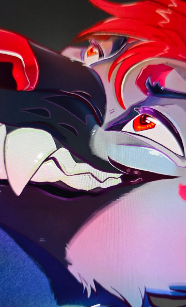 A photo of a zoomed-in digital art peice - featuring a Striped Hyena fursona face, with a black muzzle, light grey face, and a red nose, eyes, and hair. He is grinning menacingly, showing large chunky teeth.

Tags below

#conbadge #Scotiacon #SC2026 #NFC #NFC2026