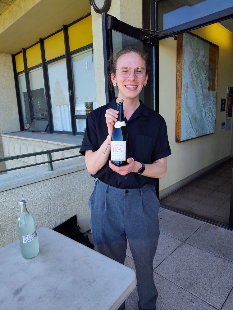 Alex holding trader joes sparkling tea!